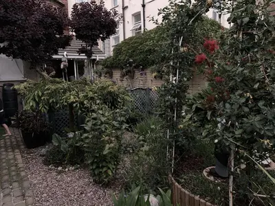 a garden with flowers and plants in front of a house at Savoy in Fleetwood