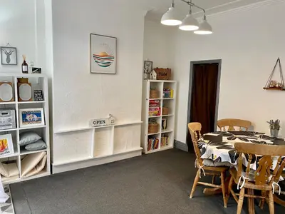 a dining room with a table and chairs at Entire holiday home in Blackpool with free parking and a private patio garden in Blackpool
