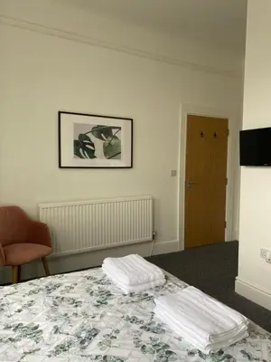 a bedroom with a bed with two towels on it at Be My Guest Liverpool in Liverpool