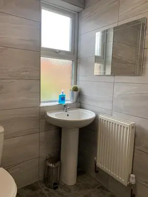 a bathroom with a sink and a toilet and a window at Be My Guest Liverpool in Liverpool
