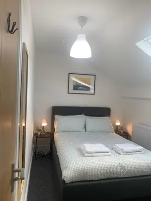 a bedroom with a bed with two towels on it at Be My Guest Liverpool in Liverpool