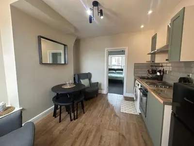 a kitchen with a table and a dining room at Sheil Road Studios - Be My Guest Liverpool in Liverpool