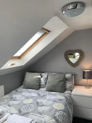 a bedroom with a bed and a skylight at Sheil Road Studios - Be My Guest Liverpool in Liverpool