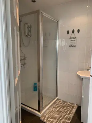 a shower with a glass door in a bathroom at Sheil Road Studios - Be My Guest Liverpool in Liverpool
