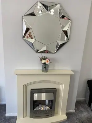 a mirror over a fireplace with a fire place at COLERIDGE LODGE in Thornton