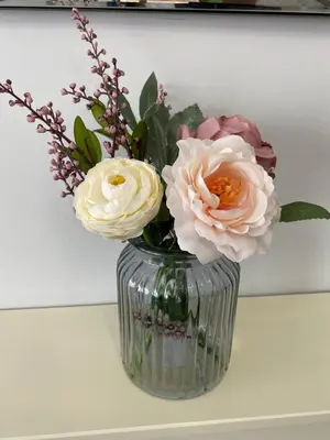 a vase with flowers in it on a table at COLERIDGE LODGE in Thornton