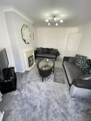 a living room with a couch and a table at COLERIDGE LODGE in Thornton