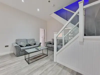 a living room with a couch and a table at DYSA Waterloo Apartments in Blackpool