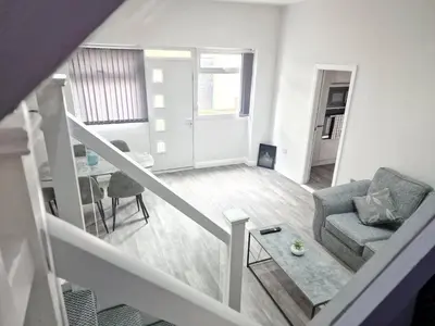 a living room with a couch and a table at DYSA Waterloo Apartments in Blackpool