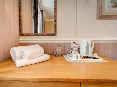 a counter top with a coffee maker and towels on it at Thistle Dhu Guest House in Blackpool