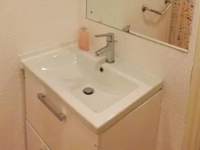 a white sink in a bathroom with a mirror at Thistle Dhu Guest House in Blackpool