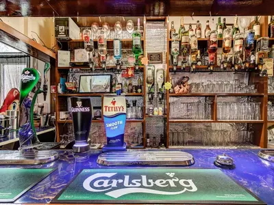 a bar filled with lots of bottles of alcohol at Thistle Dhu Guest House in Blackpool