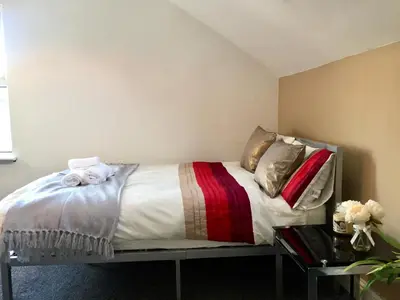 a bed with pillows on it in a room at BELMONT Apartments in Liverpool