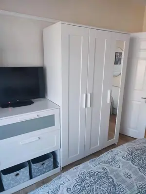 a bedroom with a tv and a white cabinet at A home away from home now with Netflix and PS4 in Blackpool