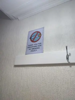 a sign on a wall with a no parking sign at A home away from home now with Netflix and PS4 in Blackpool