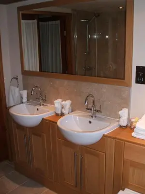 a bathroom with two sinks and a mirror at Green Bank Farmhouse in Lancaster