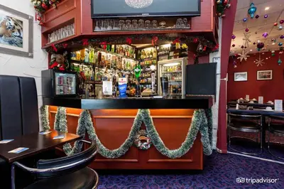 a bar in a restaurant with christmas decorations at Belmont Hotel in Blackpool