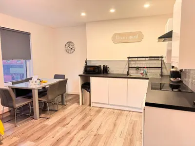 a kitchen with a table and a counter top at The Central Suite Blackpool-Best Holiday Letting Home in Blackpool in Blackpool