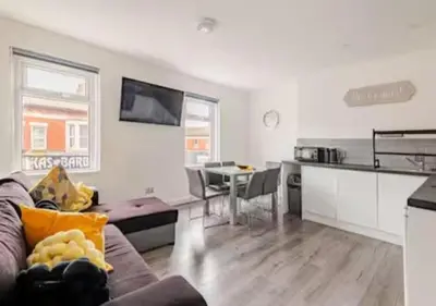 a living room with a couch and a table at The Central Suite Blackpool-Best Holiday Letting Home in Blackpool in Blackpool