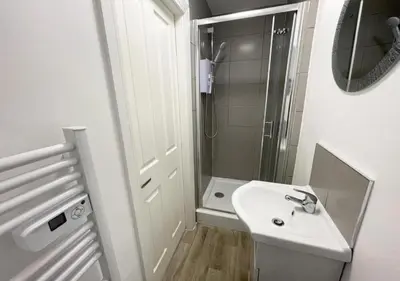 a small bathroom with a sink and a shower at The Central Suite Blackpool-Best Holiday Letting Home in Blackpool in Blackpool