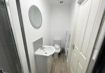 a white bathroom with a sink and a toilet at The Central Suite Blackpool-Best Holiday Letting Home in Blackpool in Blackpool