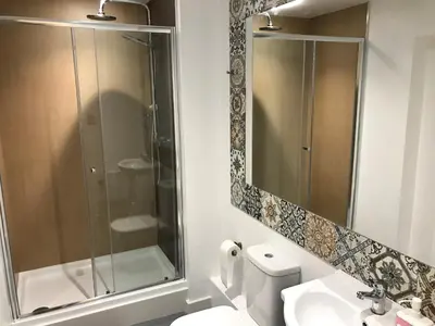 a bathroom with a shower and a toilet and a sink at Cozy Rooms in Liverpool