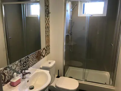 a bathroom with a toilet and a shower and a sink at Cozy Rooms in Liverpool