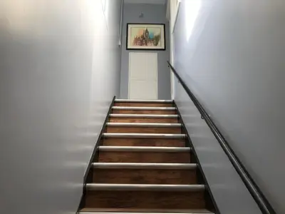 a stairway with a painting on the wall and a picture at Cozy Rooms in Liverpool