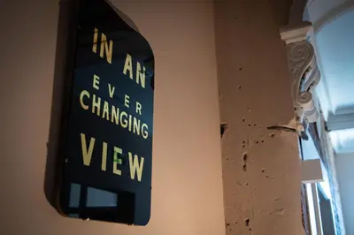 a sign hanging on a wall next to a window at ART B&B in Blackpool