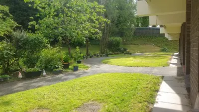 a garden with plants and a driveway at 1 Bedroom Newton Apartment l Free Parking l Wigan Royal Infirmary l Haigh Hall l Central Location in Wigan