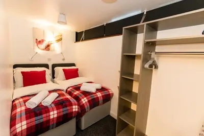 a bedroom with a bed and a book shelf at 1 Bedroom Newton Apartment l Free Parking l Wigan Royal Infirmary l Haigh Hall l Central Location in Wigan