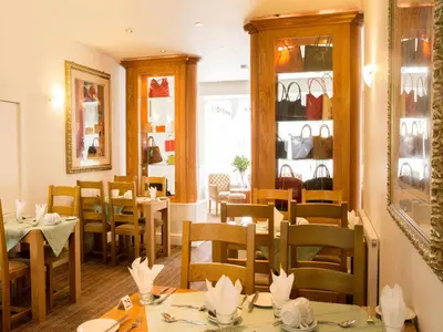 a dining room with tables and chairs in a restaurant at The Royal Alexandra Hotel by Compass Hospitality in Blackpool