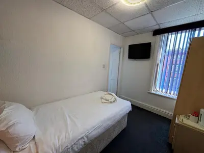 a hotel room with a bed and a television at The Royal Alexandra Hotel by Compass Hospitality in Blackpool