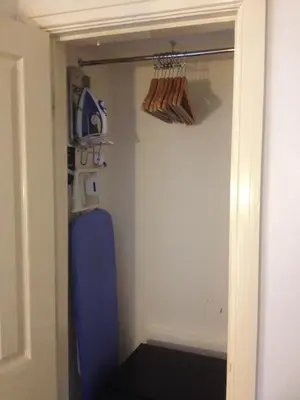 a hallway with a door to a room with a shelf at The Aspire in Blackpool
