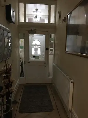 a hallway with a door with a sign on it at The Aspire in Blackpool