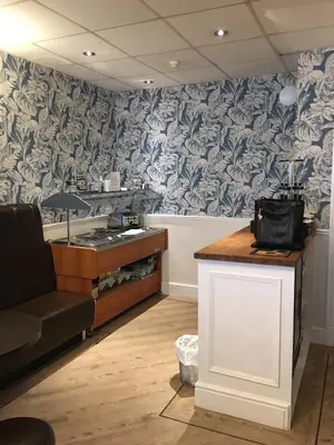 a room with a kitchen with a counter and a table at The Aspire in Blackpool