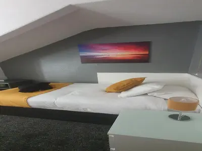 a bedroom with a bed with a painting on the wall at South Beach Kings Promenade Hotel in Blackpool