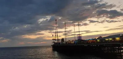 a cruise ship docked at a pier with a sunset at South Beach Kings Promenade Hotel in Blackpool