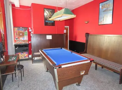 a room with a pool table and a slot machine at Willin House Hotel in Blackpool