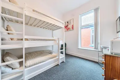 a bedroom with two bunk beds and a window at Willin House Hotel in Blackpool