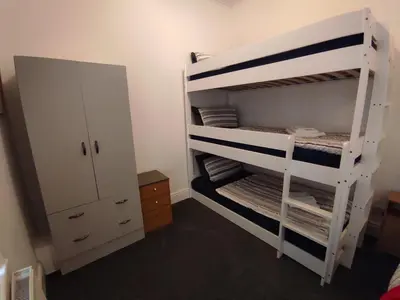 a room with a bunk bed and a cabinet at Willin House Hotel in Blackpool