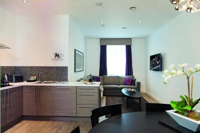 a kitchen and living room with a couch and a table at EPIC Apart Hotel - Seel Street in Liverpool