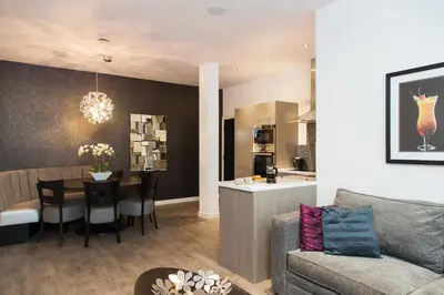 a living room and kitchen with a couch and a table at EPIC Apart Hotel - Seel Street in Liverpool