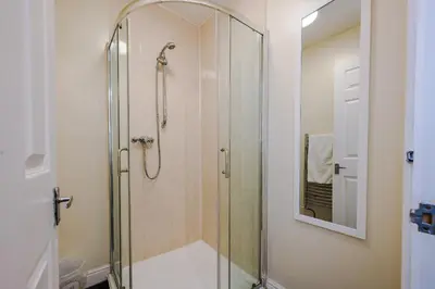 a shower with a glass door in a bathroom at Liverpool City Centre - Spacious Duplex - 6 Bedrooms - Sleeps 14 People in Liverpool