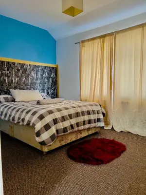 a bedroom with a large bed and a window at semi-detach in Saint Helens