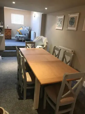 a dining room with a wooden table and chairs at Cosy house set in historic town of Clitheroe in Clitheroe