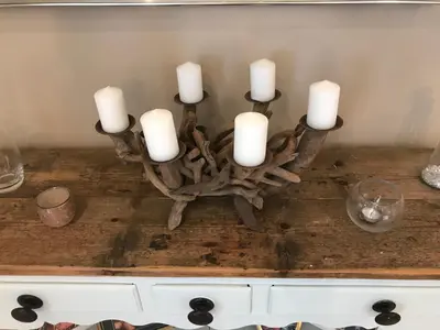 a candle holder with white candles on a table at Cosy house set in historic town of Clitheroe in Clitheroe