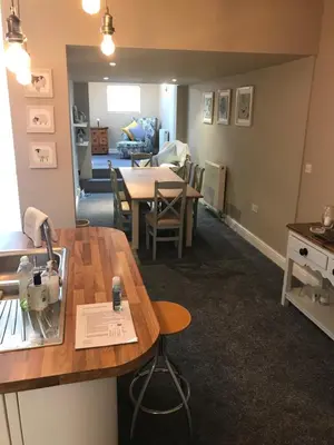 a kitchen and living room with a table and chairs at Cosy house set in historic town of Clitheroe in Clitheroe