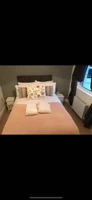 a bedroom with a large bed with two towels on it at Cosy house set in historic town of Clitheroe in Clitheroe