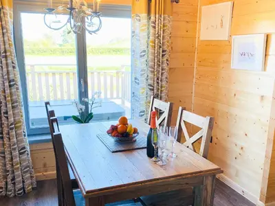 a wooden table with a bowl of fruit on it at Cedar Lodge - Uk30008 in Lindal in Furness